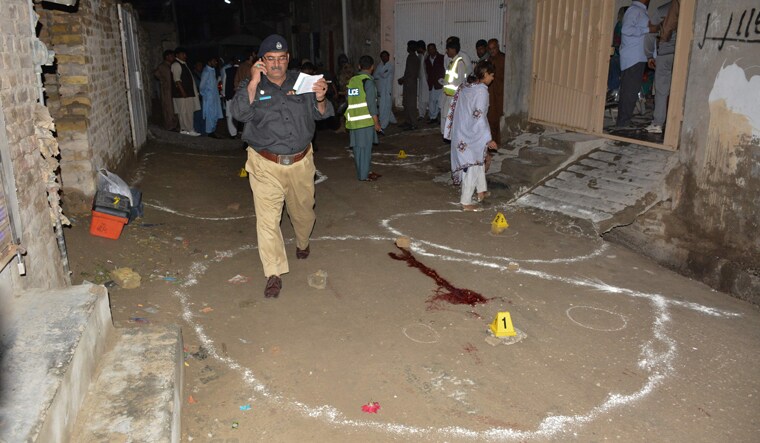 Pakistani investigators collect evidence at the shooting site outside a church in Quetta | AFP