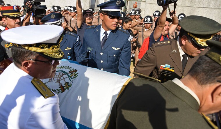 Military personnel carry the coffin of former Guatemalan dictator retired General Jose Efrain Rios Montt | AFP