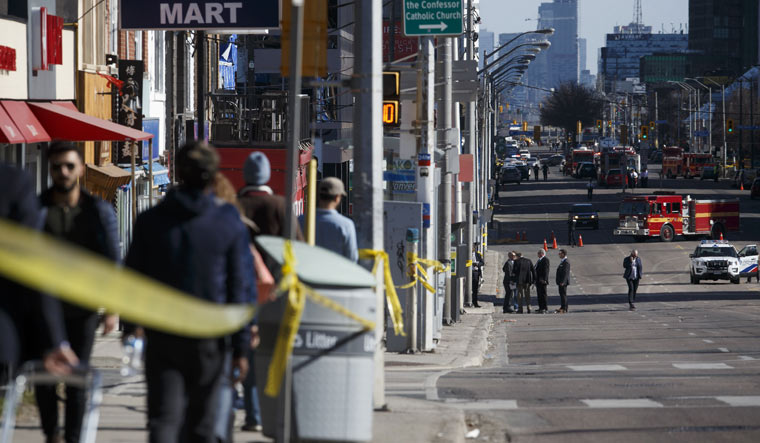 Police work the scene on Yonge St. near Finch Ave in Toronto after a van plowed into pedestrians | AFP