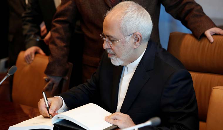 Iran's Foreign Minister Mohammad Javad Zarif signs a guest book during a meeting with United Nations Secretary General Antonio Guterres after the two attended a High-Level Meeting on Peacebuilding and Sustaining Peace at United Nations | Reuters