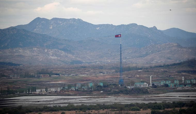 A North Korean flag flutters on top of a 160-metre tower in North Korea's propaganda village of Gijungdong | Reuters