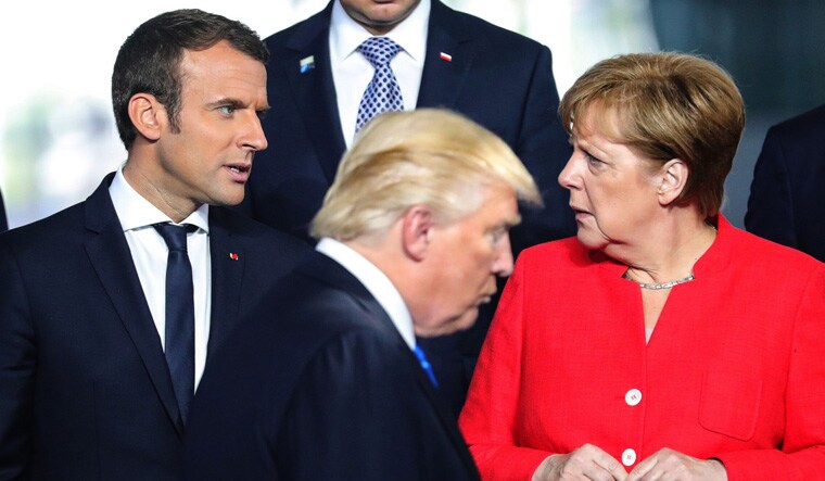 [File] French President Emmanuel Macron, US President Donald Trump and German Chancellor Angela Merkel during NATO Summit in Brussels, Germany in 2017 | Reuters