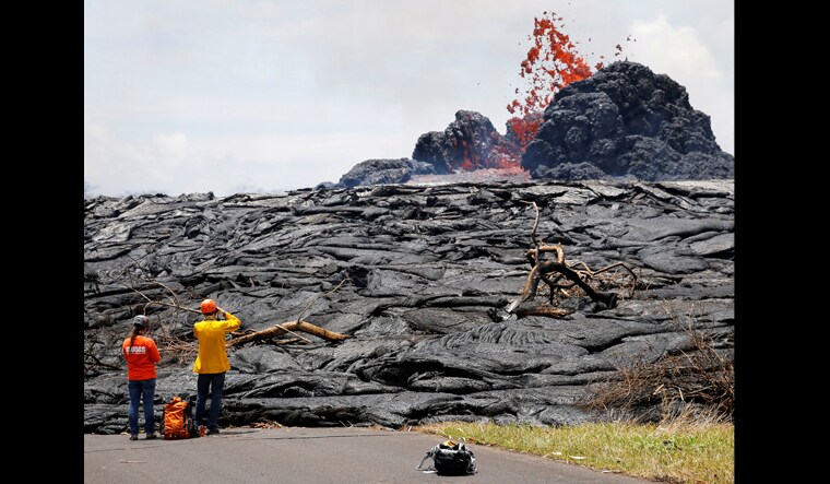 Sarah Conway, left, Matt Patrick, both from USGS Hawaiian Volcanos, observe lava erupting from a fissure in the Leilani Estates near Pahoa, Hawaii, US | Reuters 