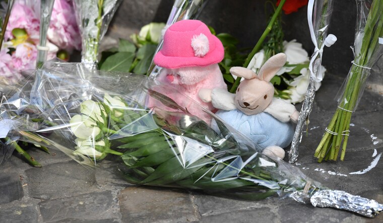 Flowers are left at the scene of a shooting in Liege, Belgium | AP