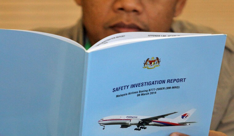 A family member reads an MH370 briefing report before a closed door meeting in Putrajaya, Malaysia July 30, 2018 | Reuters