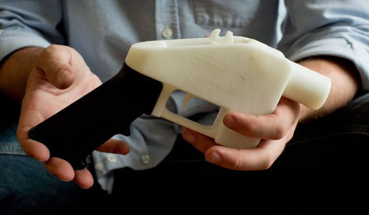 Cody Wilson holds what he calls a Liberator pistol that was completely made on a 3-D-printer at his home in Austin, Texas | AP