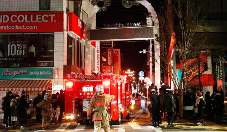 Police and firefighters inspect around the site of the attack near Takeshita Street | AP