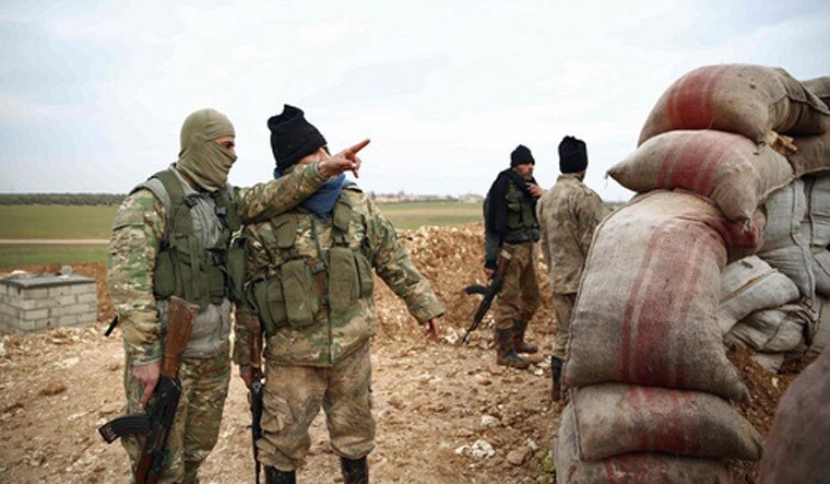 Turkish-backed Syrian opposition fighters hold a position near the village of Hamran, northwest of the northern Syrian town of Manbij | PTI