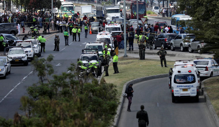 Police and security personnel work at the scene where a car bomb exploded, according to authorities, in Bogota | Reuters
