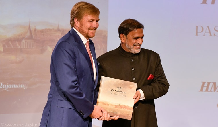 King Willem-Alexander of the Netherlands receiving the first copy of 'India and the Netherlands, Past, Present and Future' from Indian Ambassador Venu Rajamony