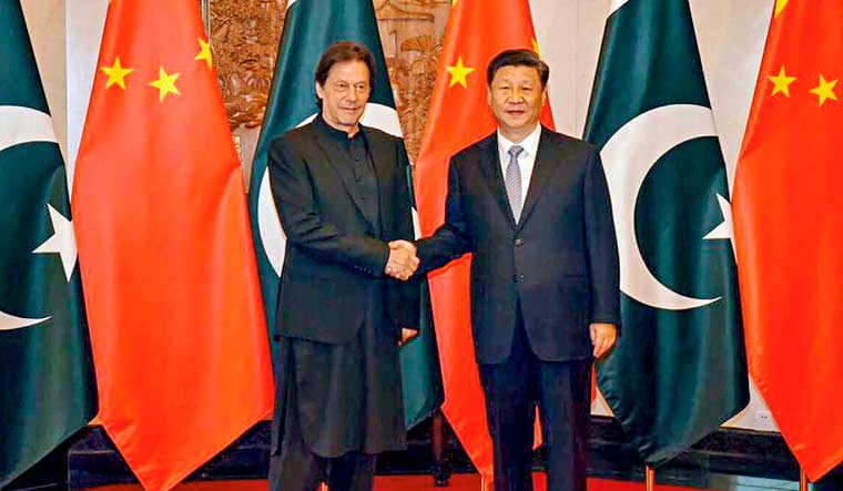 Chinese President Xi Jinping shakes hands with Pakistani Prime Minister Imran Khan, in Beijing | PTI