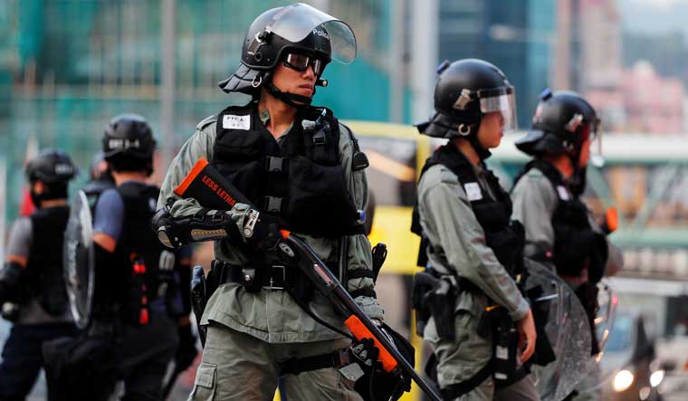 Police officers are seen during a protest against the invocation of the emergency laws in Hong Kong, China | Reuters