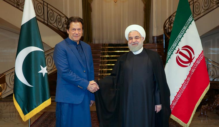 Iranian President Hassan Rouhani shakes hands with Pakistani Prime Minister Imran Khan in Tehran, Iran, October 13, 2019 | Reuters