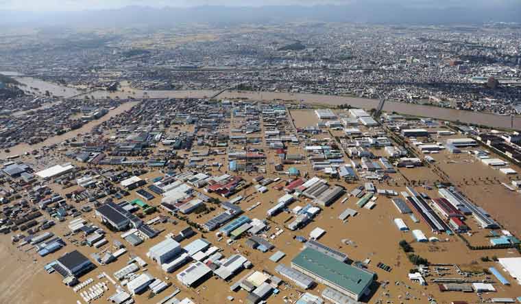 This aerial view shows a flooded area besides the Abukuma river in Koriyama, Fukushima prefecture on October 13, 2019, one day after Typhoon Hagibis swept through central and eastern Japan | AFP