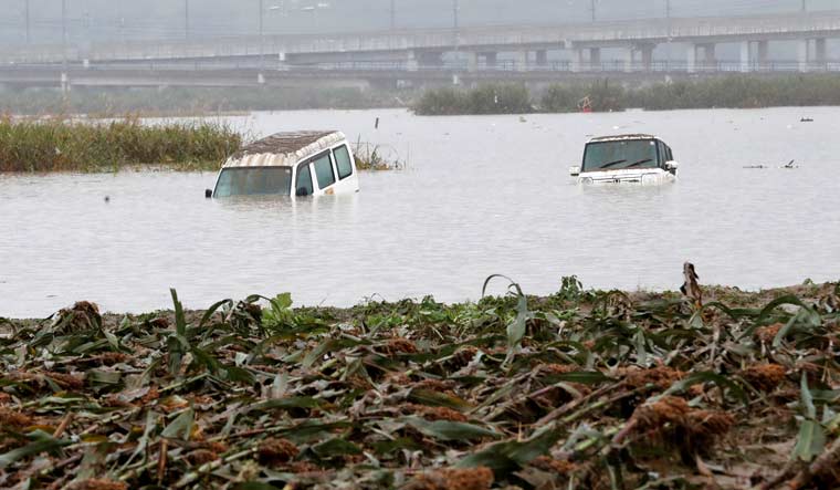 Partially submerged cars are seen in the aftermath of Typhoon Hagibis, which caused severe floods, near the Chikuma River in Nagano Prefecture, Japan, October 14, 2019 | Reuters