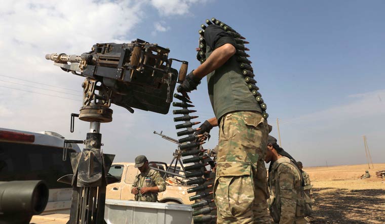 Turkish-backed Syrian opposition fighters deploy near the town of Ras al-Ayn, Syria, Friday, Oct. 19, 2019. Fighting between Turkey and Kurdish forces continued Friday in Ras al-Ayn despite a U.S.-brokered cease-fire that went into effect overnight. | AP