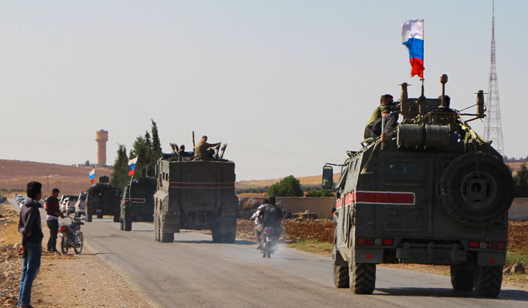 A convoy of Russian military vehicles drives toward the northeastern Syrian city of Kobane on October 23, 2019 | AFP