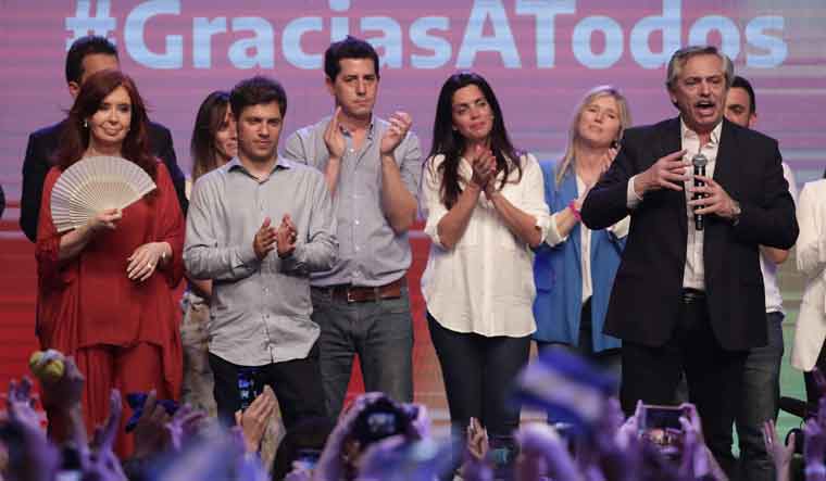 Argentina's president elect Alberto Fernandez [right] delivers a speech next to his vice-president elected Cristina Fernandez [left] and Buenos Aires Governor elected Axel Kicillof [second left] at the party's headquarters in Buenos Aires | AFP