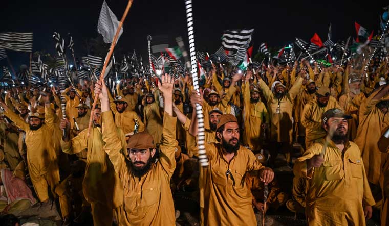 Supporters of Islamic political party Jamiat Ulema-e-Islam (JUI-F) react as they listen to the speech of their leader Maulana Fazlur Rehman during an anti-government 