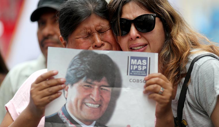 A person holds a picture of Bolivian President Evo Morales during a demonstration in support of him after he announced his resignation on Sunday, in Buenos Aires, Argentina | Reuters