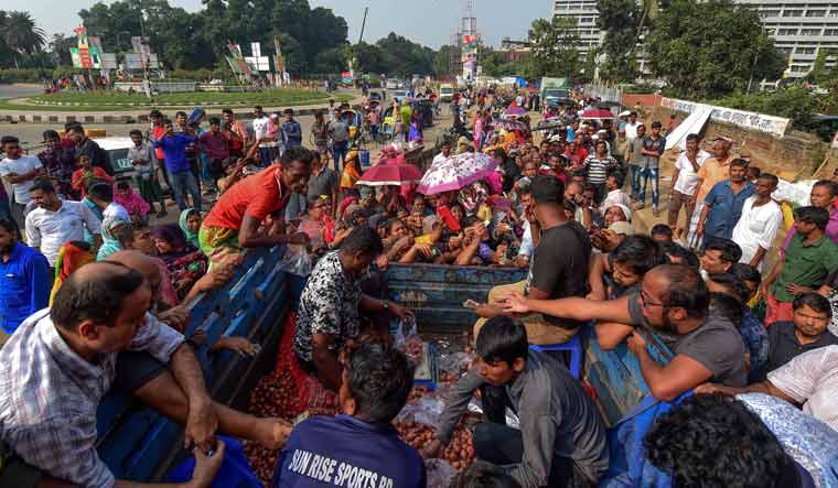 People scuffle as they purchase subsidised onions in Dhaka on November 17, 2019 | AFP