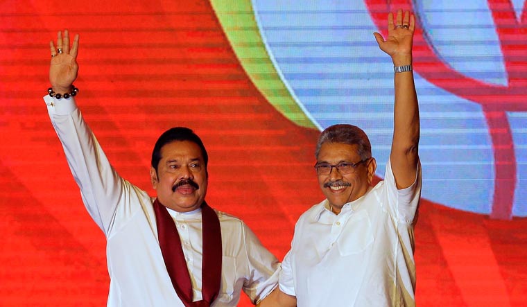 In this Aug. 11, 2019, file photo, former Sri Lankan President Mahinda Rajapaksa, left, and his brother and former Defense Secretary Gotabaya Rajapaksa wave to supporters | AP