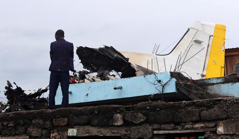 A man stands at the site where a Dornier 228-200 plane operated by local company Busy Bee crashed into a densely populated neighbourhood in Goma, eastern Democratic Republic of Congo November 24, 2019 | Reuters