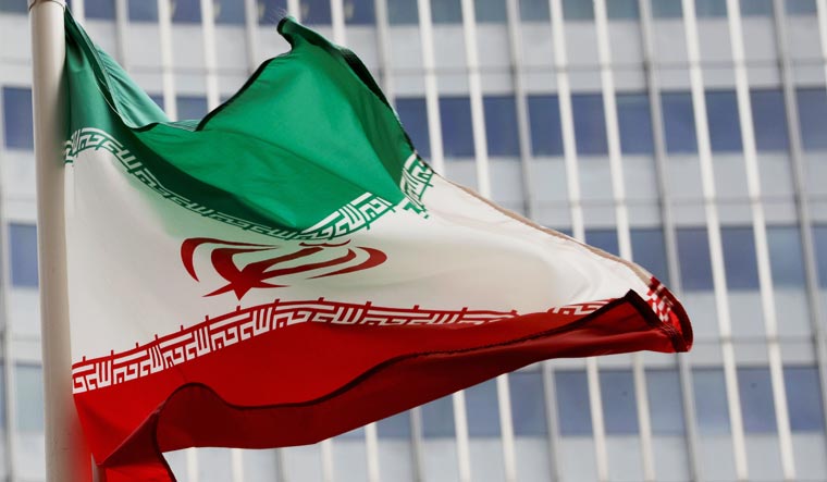 File photo: An Iranian flag flutters in front of the International Atomic Energy Agency (IAEA) | Reuters