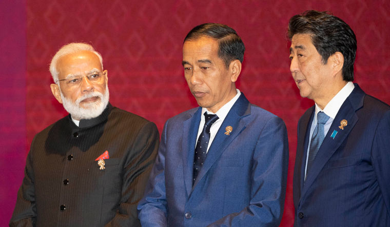  From Left to Right; India's Prime Minister Narendra Modi, Indonesia's President Joko Widodo, and Japan's Prime Minister Shinzo Abe talk before a group photo during the East Asia summit in Nonthaburi, Thailand, Monday | AP
