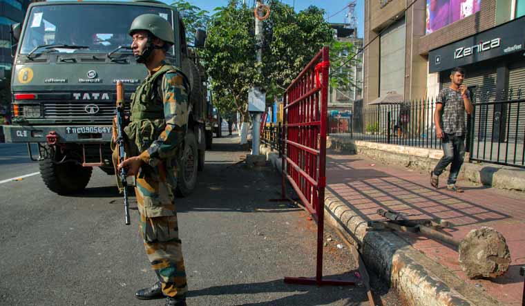 An Indian army soldier stands guard during curfew in Gauhati, India | AP