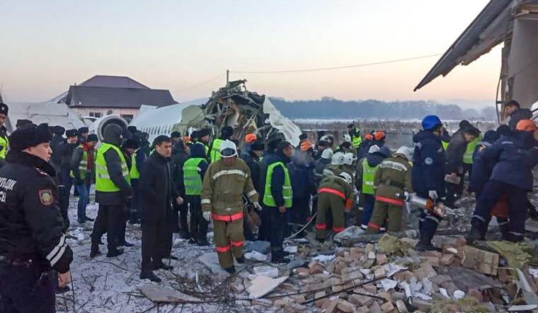 Resquers working at the site of a passenger plane crash outside Almaty | AFP