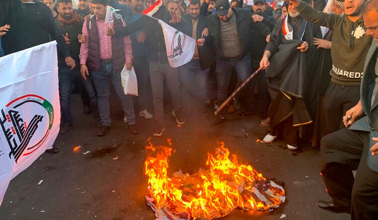 Protesters burn representations of a US flag during a protest against the US strikes on the Hezbollah Brigades militia | AP