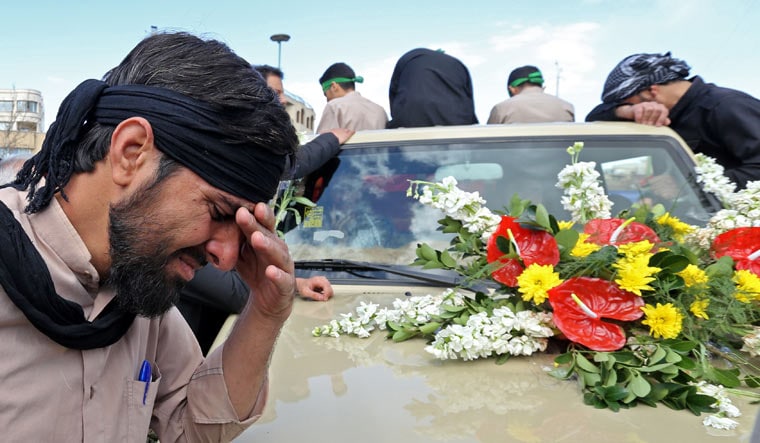 An Iranian man cries during the funeral of 27 Revolutionary Guards, who were killed in a suicide attack, in southeastern city of Isfahan | AFP