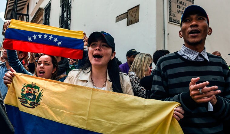 Supporters of Venezuelan acting president Juan Guaido demonstrate in front of the Foreign Ministry in Bogota as he holds a meeting with members of a multinational support group in the framework of the Lima Group to discuss a joint strategy to resolve Venezuela's crisis | AFP