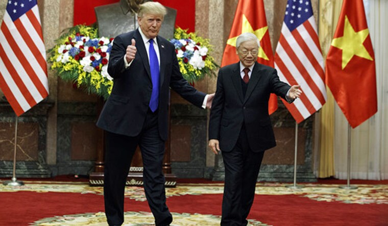 President Donald Trump walks with Vietnamese President Nguyen Phu Trong at the Presidential Palace | AP