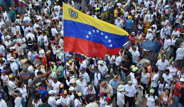 Supporters of Venezuelan opposition leader and self-proclaimed acting president Juan Guaido take part in a demonstration in Caracas | AFP
