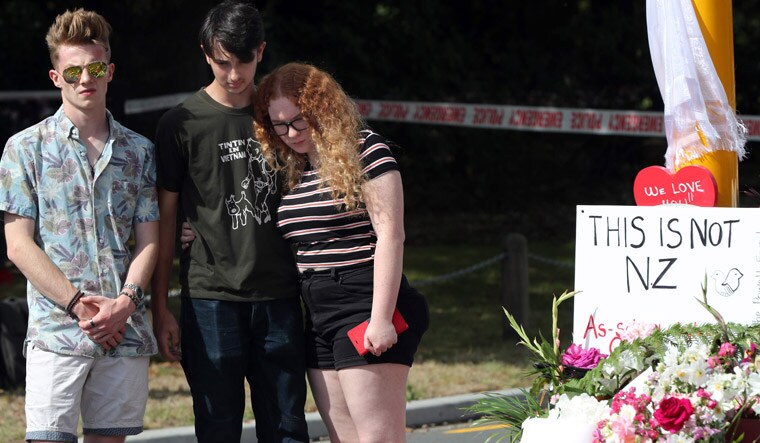 Residents pay their respects by placing flowers for the victims of the mosques attacks | AFP