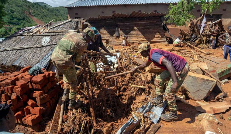Soldiers help residents retrieve their lost belongings on March 19, 2019 Chimanimani as the military was deployed to assist civilians, after the area was hit by the Cyclone Idai | AP
