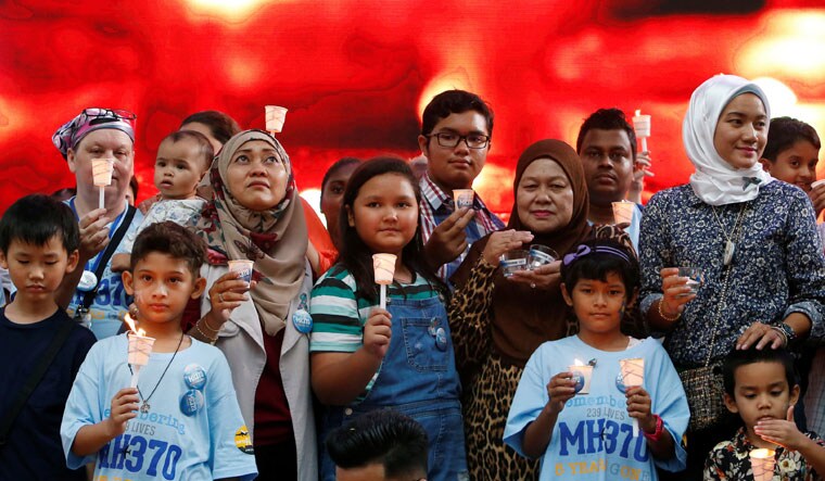 People gather and hold candles during the MH370 remembrance event in Kuala Lumpur | Reuters