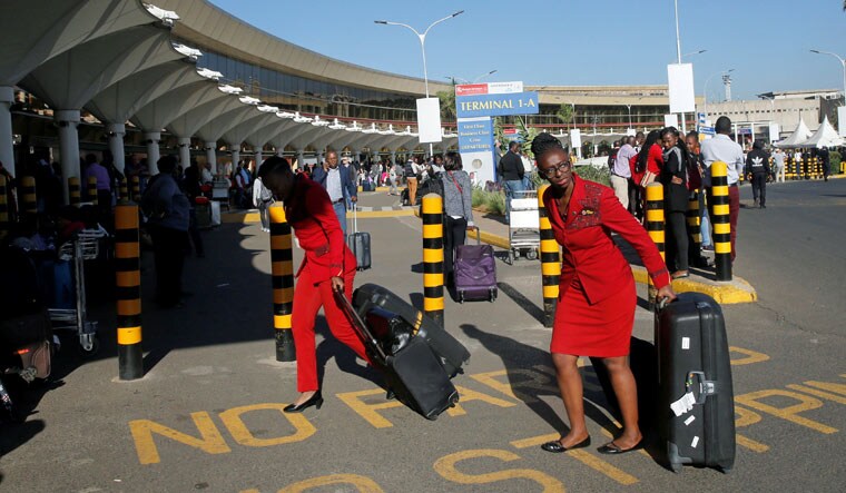 Kenya Airways workers pull their flight cases at the Jomo Kenyatta International Airport during a labour dispute that grounded flights near Nairobi, Kenya | Reuters