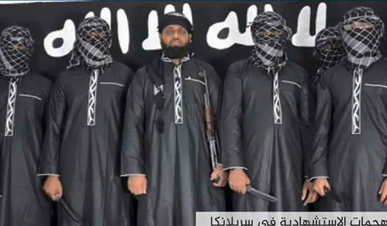 An image grab taken from a press release issued on April 23, 2019 by the Islamic State (IS) group's propaganda agency Amaq, allegedly shows five of the eight men it said carried out a string of deadly suicide bomb blasts on Easter Sunday in Sri Lanka, lined up at an undisclosed location. The man in the centre is believed to be Zahran Hashim, who was identified by the Sri Lankan police as the leader of the Islamist National Thowheeth Jama'ath (NTJ) group, which Colombo has blamed for the attacks | AFP
