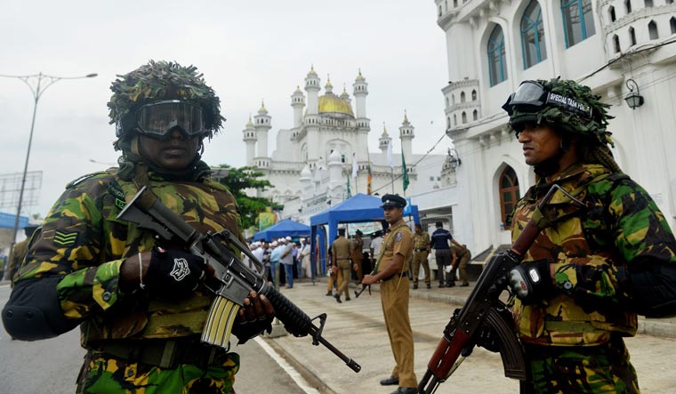 Security personnel stand guard outside a mosque during Friday noon prayer in Colombo | AFP