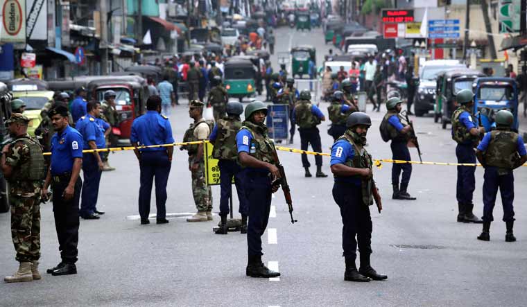 Sri Lankan Naval soldiers stand guard as authorities started clearing the debris from inside of the damaged St. Anthony's Church after it was targeted in a series of Islamic State-claimed suicide bombings that killed hundreds of people during Easter Sunday | AP