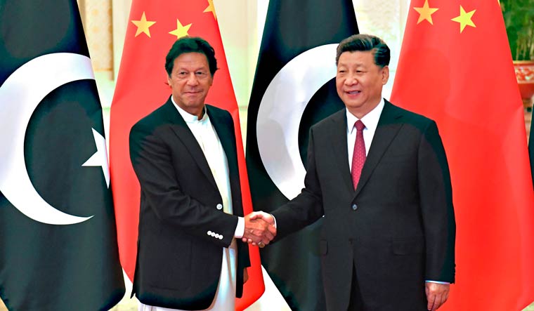 China's President Xi Jinping shakes hands with Pakistan's Prime Minister Imran Khan | AFP