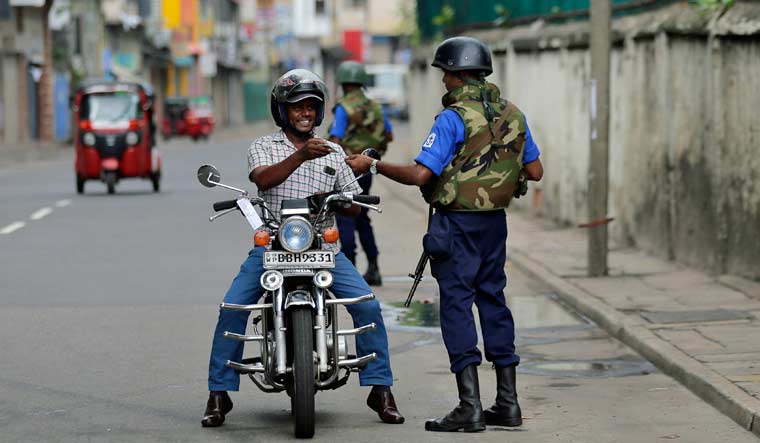 Sri Lankan naval soldiers check the identity of a motorists in Colombo, Sri Lanka, on Wednesday | AP