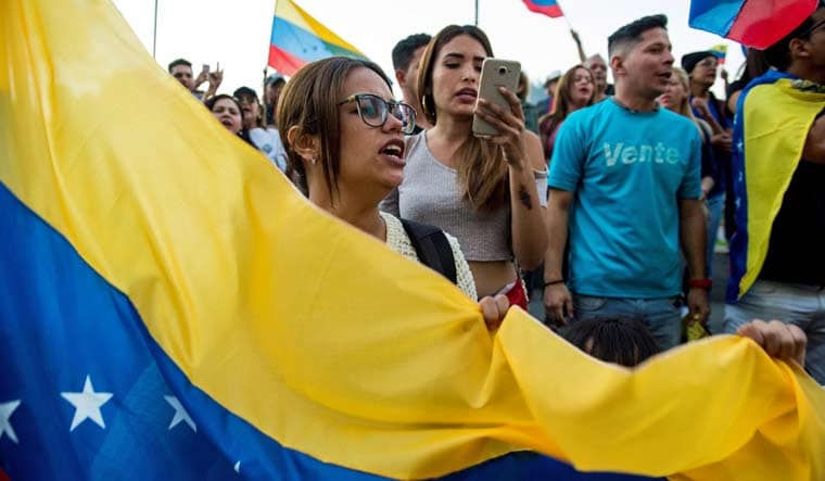 Venezuelan citizens living in Chile shout slogans during a demonstration against president Nicolas Maduro's government in Santiago, Chile | AFP