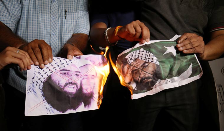 People in Ahmedabad burn posters of Masood Azhar after news of him being designated a global terrorist by the UN emerged | Reuters