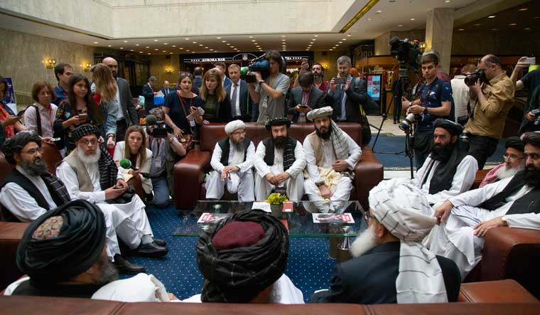 Mullah Abdul Ghani Baradar, the Taliban group's top political leader, left, Sher Mohammad Abbas Stanikzai, the Taliban's chief negotiator, second left, and other members of the Taliban delegation speak to reporters prior to their talks in Moscow | AP
