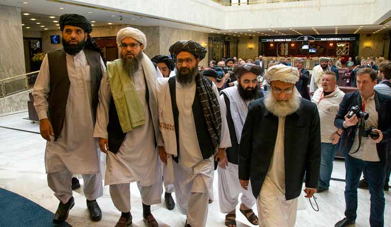 Mullah Abdul Ghani Baradar, the Taliban group's top political leader, third from left, arrives with other members of the Taliban delegation for talks in Moscow, Russia | AP