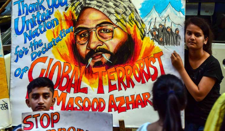 Students hold up posters as Jaish-e-Mohammad head Masood Azhar was blacklisted by UN Security Council committee, in Mumbai | PTI